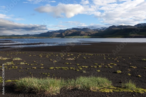 Volcanic landscape with black lava beach, mountains and clouds, Oxarfjordur Bay, Northern Iceland, Iceland, Europe photo