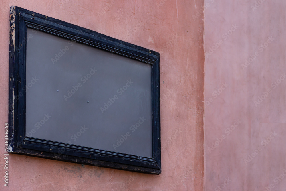 Fototapeta premium Empty mockup wooden painted frame gray template on pink grunge building wall for street advertisement. Modern startup promotion. Real texture.