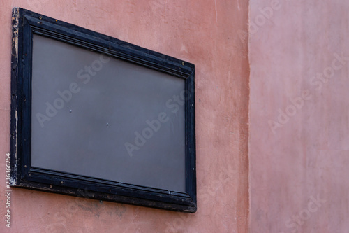 Empty mockup wooden painted frame gray template on pink grunge building wall for street advertisement. Modern startup promotion. Real texture.