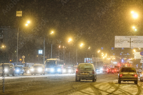 Moscow, Russia - November, 28: cars on a highway in an evening at snowstorm