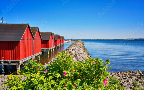 Breakwater line along Red fisher houses in the port Weiße Wiek in Boltenhagen on the Baltic Sea. Germany