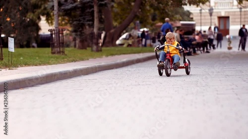 Wallpaper Mural Happy child on red bike having fun outdoors. Active kid boy riding retro stylish bicycle. Cute smiling little boy playing and cycling on street road and spending family time. Slow motion video. Torontodigital.ca
