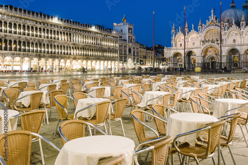 Empty tables and chairs in Piazza San Marco in the evening