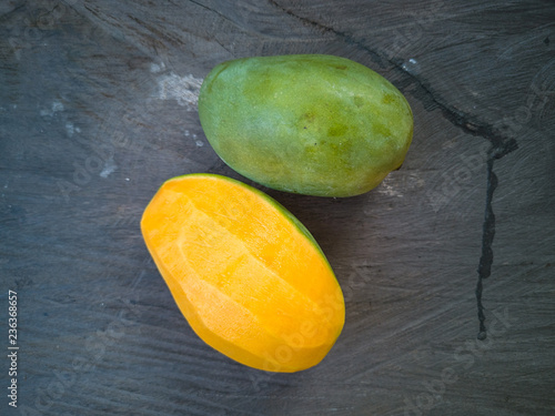 Selective focus of Malaysian or Asian favourite mango fruit called Mangga Harum Manis or Harumanis on the top of wooden table. photo