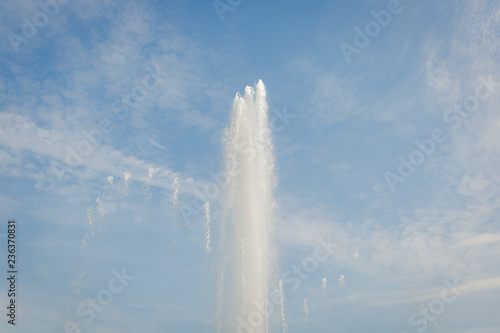 Water jets of a fountain with blue sky background.Close up of musical fountain in Margaret Island, Budapest, Hungary spouting in the air.Water splashing from the fountain in the background of blue sky
