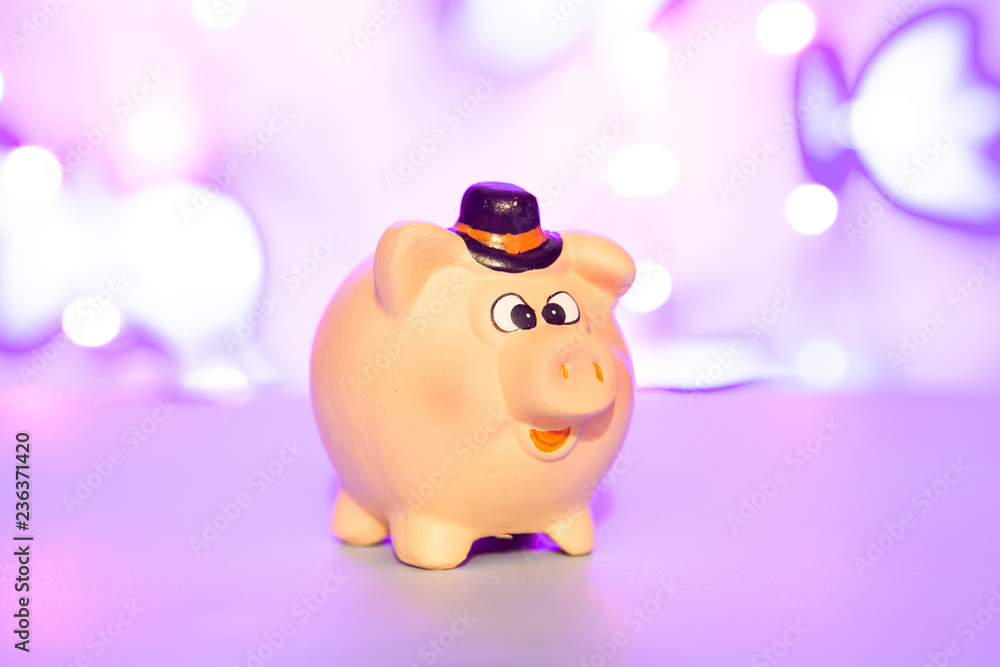 Piggy bank on purple blurred background, concept of saving money Piggy bank on purple blurred background, concept of saving money