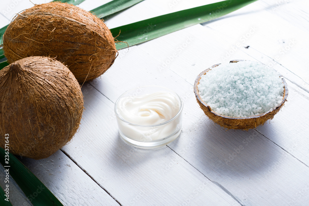 coconut moisturizer cream and bath salt , on white wood table coconut moisturizer cream and bath salt , on white wood table