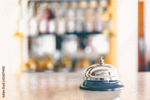 Ring bell for staff calling on the stand. Reception and bar background. Holiday and travel concept