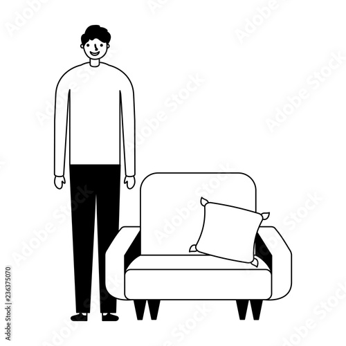 man standing near sofa with cushion