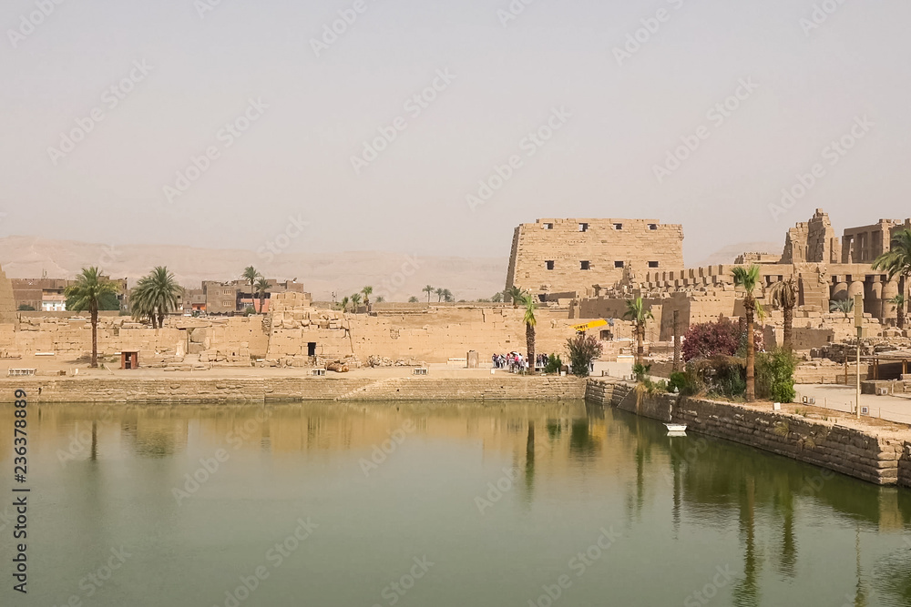 A pond near the ancient Egyptian buildings and ruins