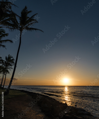 sun rising & reflecting on the ocean in Kauai, Hawaii, USA