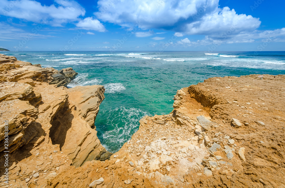 View of the ocean from the rocky cliffs of the Mahaulepu Heritage Beach Trail in Kauai, Hawaii, USA View of the ocean from the rocky cliffs of the Mahaulepu Heritage Beach Trail in Kauai, Hawaii, USA