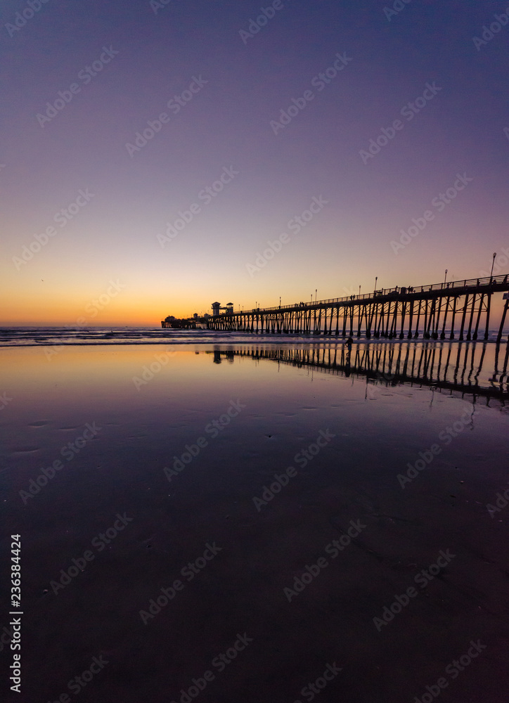 pier during colorful sunset in Oceanside, California, USA