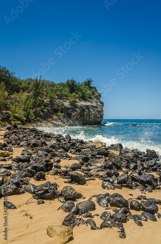 A cliff & rocks along the shore at Shipwrecks Beach, Kauai, Hawaii, USA © KevinClarkArt