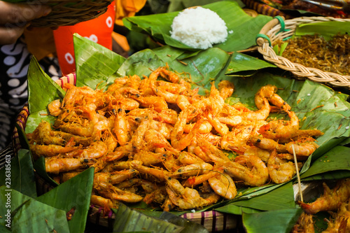 spicy fried shrimp served in green banana leaf from central java © teguhjatipras