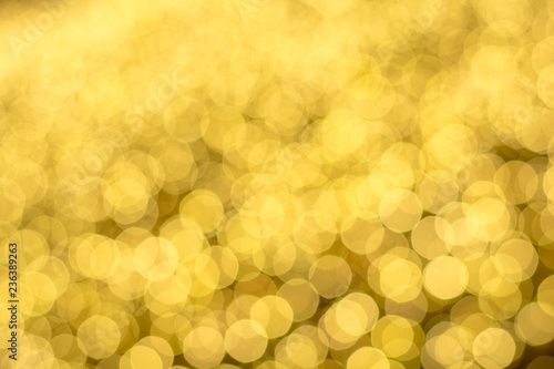 Christmas lights blurred into bokeh on a yellow field.