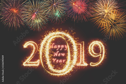 Happy new year 2019 written with Sparkle firework on fireworks with dark background, celebration and greeting cards concept
