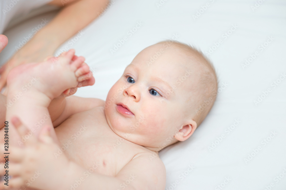 mother is playing with her baby son in the bedroom mother is playing with her baby son in the bedroom