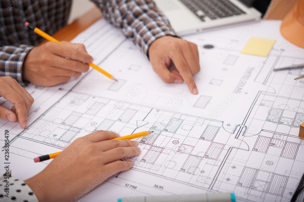 Close-up image of professional engineers discussing construction plan at meeting Close-up image of professional engineers discussing construction plan at meeting