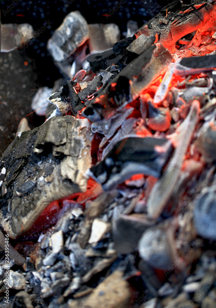 burning coals in the barbecue on a blurred background, the texture of the flame burning coals in the barbecue on a blurred background, the texture of the flame