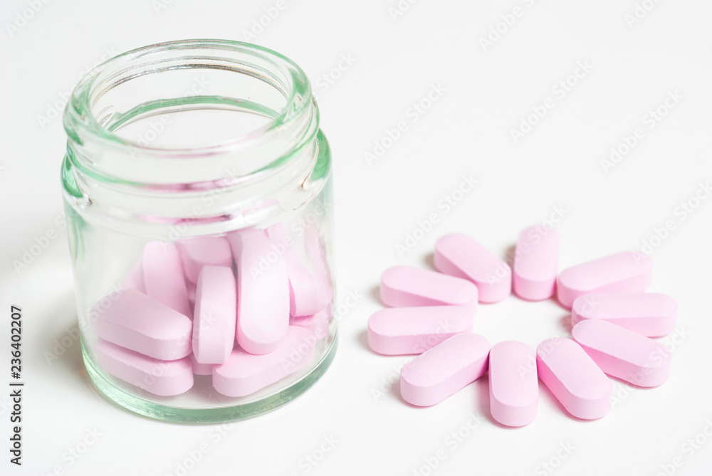 Pink medicine vitamin pills on white Pink medicine vitamin pills on white