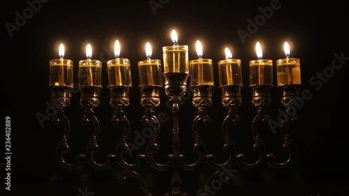 Loop video. The 8th day of the Jewish holiday of Hanukkah. Beautiful Lit Hanukkah Menorah On Dark Background