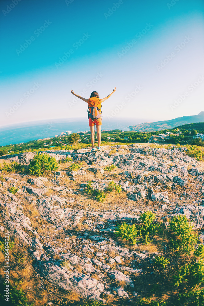 Fototapeta premium Girl at the top of the mountain.