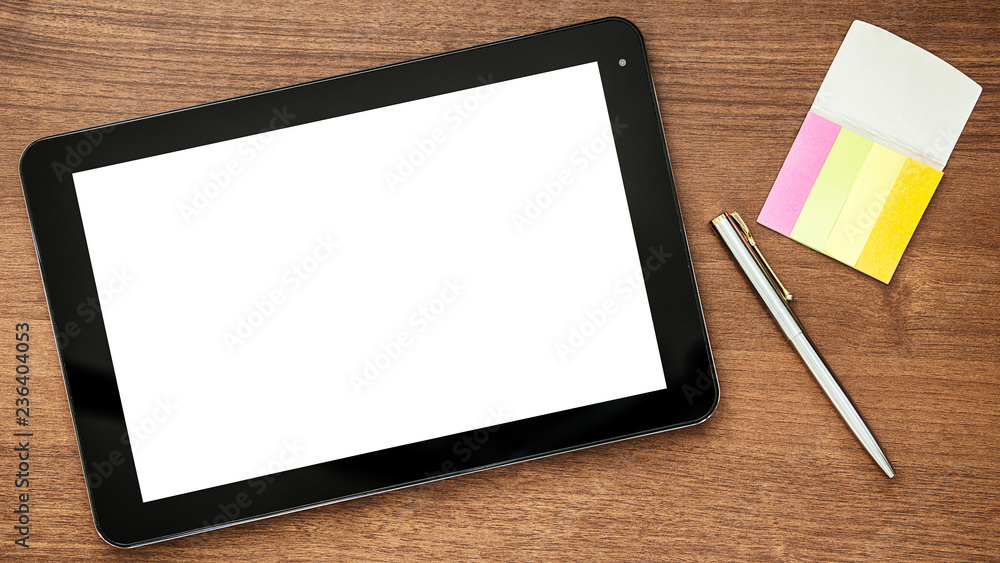 Digital tablet computer, papers and pen on a wooden table. Digital tablet computer, papers and pen on a wooden table.