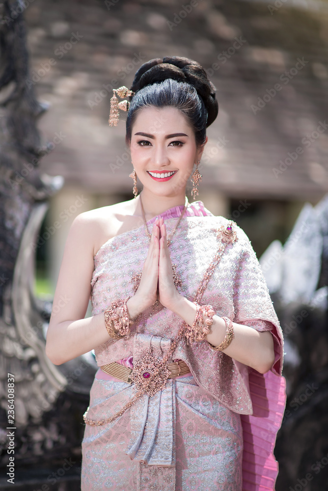 Beautiful Thai girl in Thai traditional costume. Stock Photo Adobe Stock