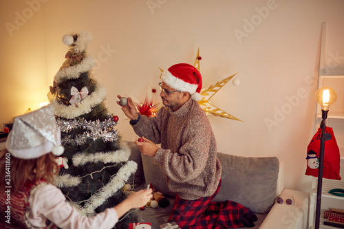 Father and daughter enjoying at Christmas  / New Year's time.