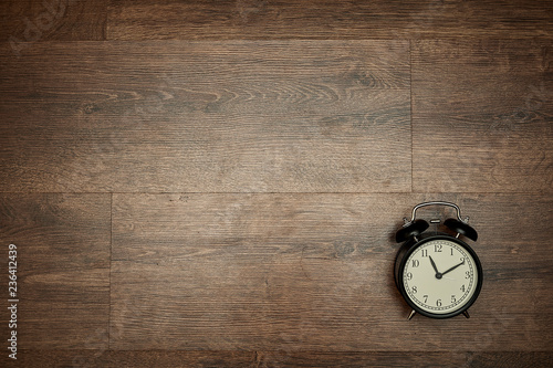 pointer clock on wood background