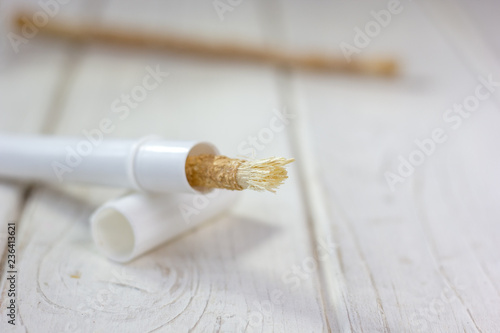 Miswak or siwak - arabian toothbrush for tooth cleaning on white. photo