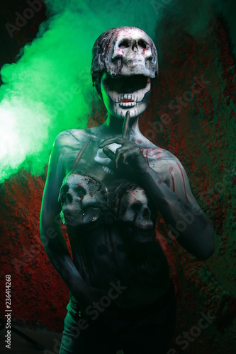 zombie death girl with scary body art posing in the night in thesmoke alone