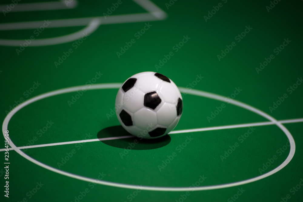 Toy plastic soccer ball on the football field