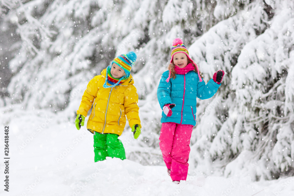 Child playing with snow in winter. Kids outdoors. Child playing with snow in winter. Kids outdoors.