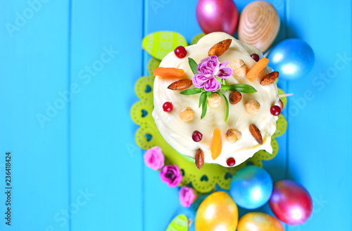 Easter background. Beautiful easter cake with decorations and colorful eggs on a wooden table. photo