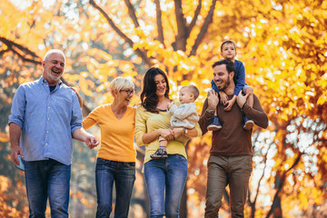 Multl generation family in autumn park having fun