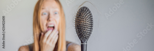 Hair loss in women concept. A lot of lost hair on the comb BANNER, LONG FORMAT photo