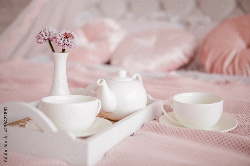 Breakfast in bed with flowers and white cups. Breakfast in bed with flowers and white cups.