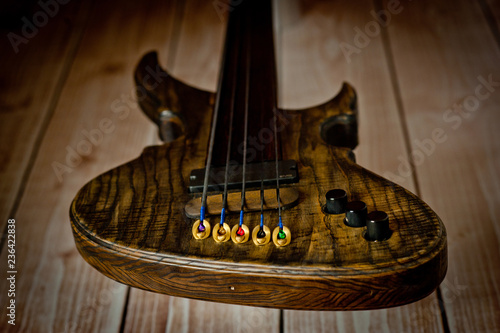 Fragment of electric wood electric bass deck