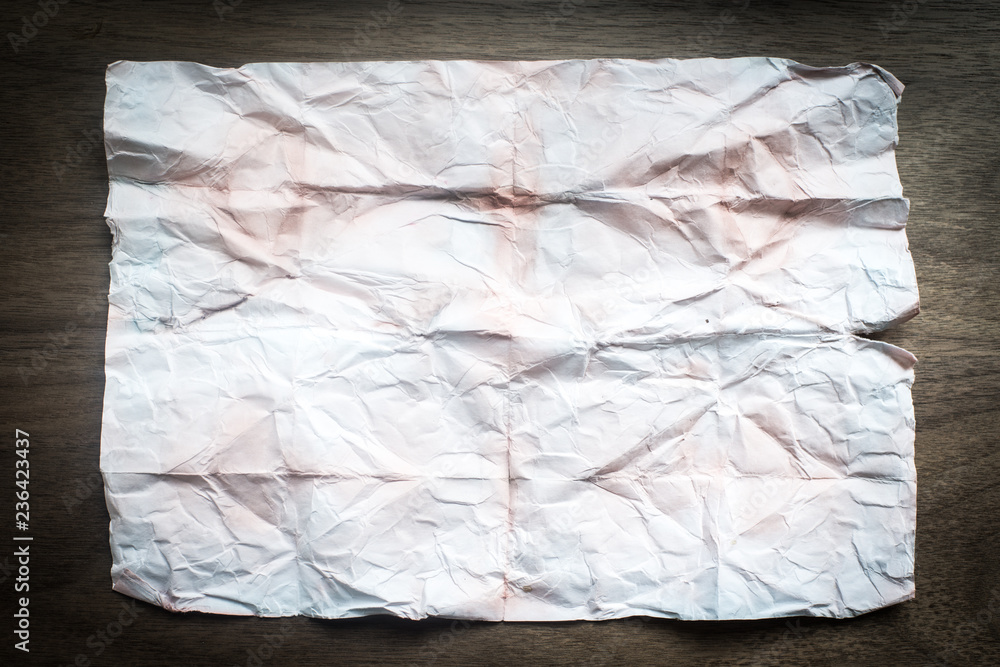 Creased Blank Paper on Wooden Background Creased Blank Paper on Wooden Background