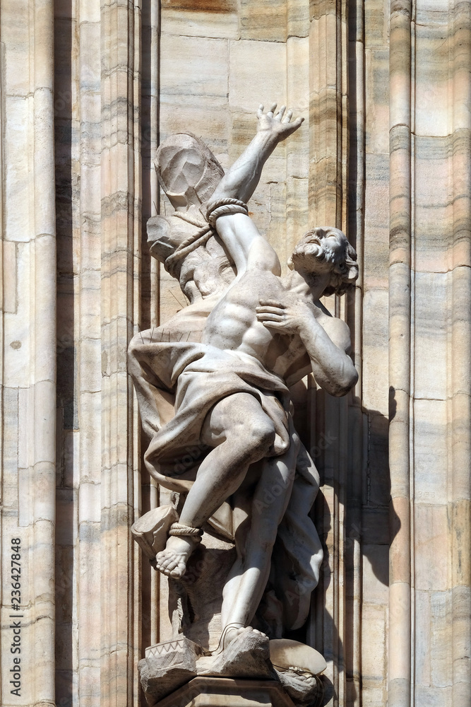 Statue of Saint on the facade of the Milan Cathedral, Duomo di Santa Maria Nascente, Milan, Lombardy, Italy Statue of Saint on the facade of the Milan Cathedral, Duomo di Santa Maria Nascente, Milan, Lombardy, Italy