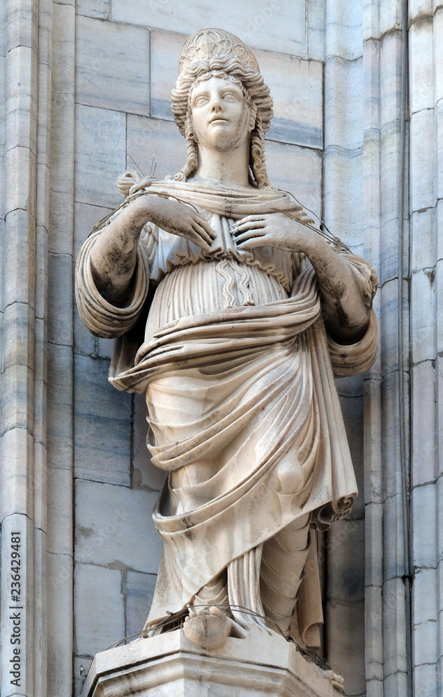 Statue of Saint on the facade of the Milan Cathedral, Duomo di Santa Maria Nascente, Milan, Lombardy, Italy Statue of Saint on the facade of the Milan Cathedral, Duomo di Santa Maria Nascente, Milan, Lombardy, Italy
