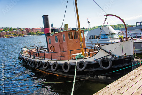 Photography tow moored to a wooden embankment in stockholm city. sweden