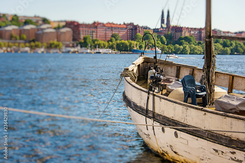 Photography bow and deck of old pleasure boat moored to a embankment with panorama of stockh