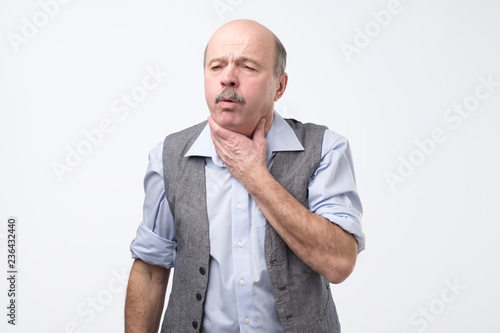 Senior man coughing being ill. Studio shoot. Flu or asthma health problem © Viktor Koldunov