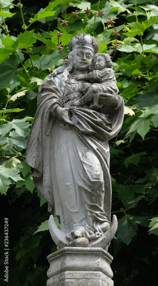 The statue of the Virgin Mary with the child Jesus in the courtyard of the church of St. Leodegar in Lucerne, Switzerland The statue of the Virgin Mary with the child Jesus in the courtyard of the church of St. Leodegar in Lucerne, Switzerland