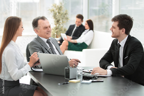 client talking with the staff at the Desk in the office