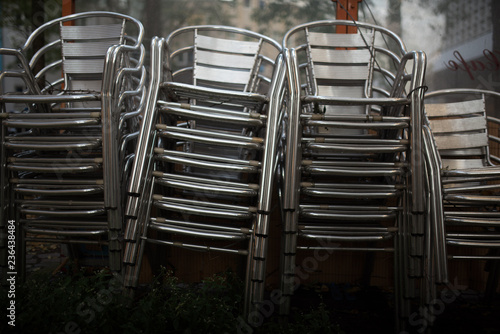 stacked chairs in front of a wall