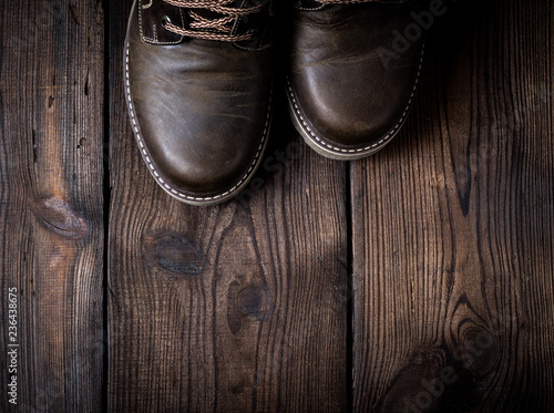 pair of leather brown shoes on a wooden background © nndanko